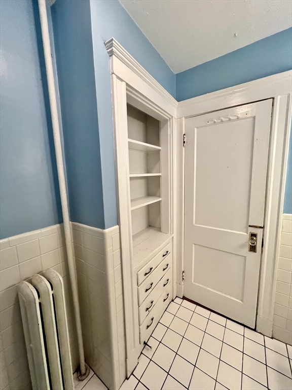 138 Fuller Street, Unit 3 Brookline, MA 02446 - Photo 16 of 27 a view of walk in closet with empty racks