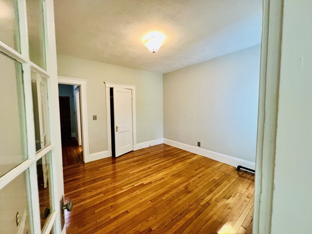 138 Fuller Street, Unit 3 Brookline, MA 02446 - Photo 21 of 27 a view of empty room with wooden floor