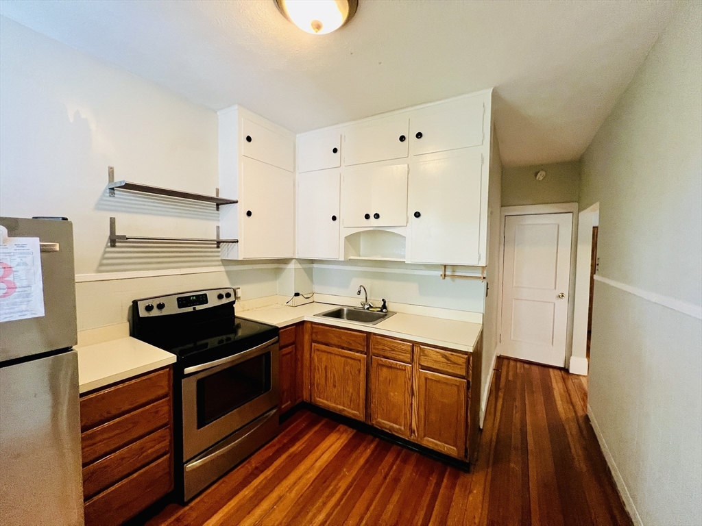 138 Fuller Street, Unit 3 Brookline, MA 02446 - Photo 5 of 27 a kitchen with a sink and wooden floor
