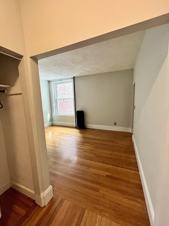 138 Fuller Street, Unit 3 Brookline, MA 02446 - Photo 9 of 27 a view of a livingroom with wooden floor