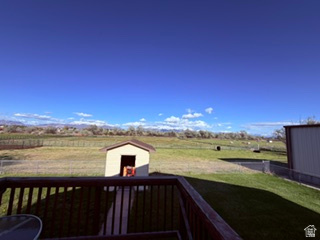 588 North 4500 West West Point, UT 84015 - Photo 55 of 61 Spacious outdoor decking with dark wood railings overlooking a large grass area