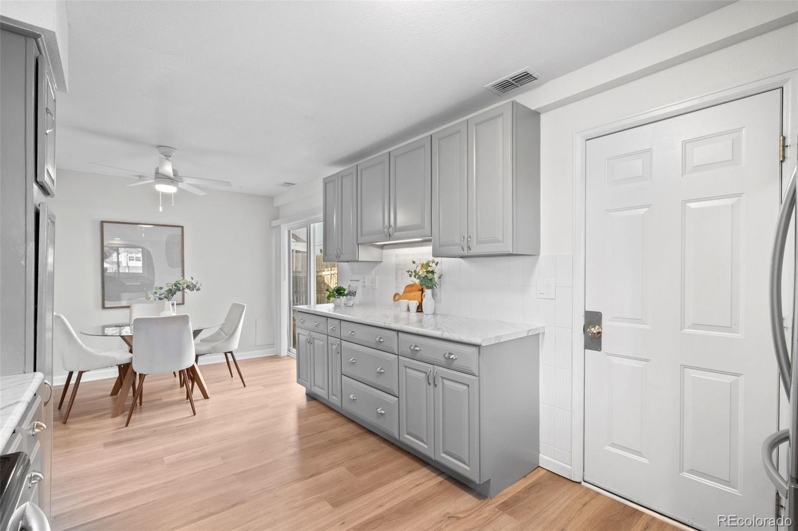 16373 East Rice Place, Unit B Aurora, CO 80015 - Photo 15 of 26 a kitchen with a cabinets and wooden floor