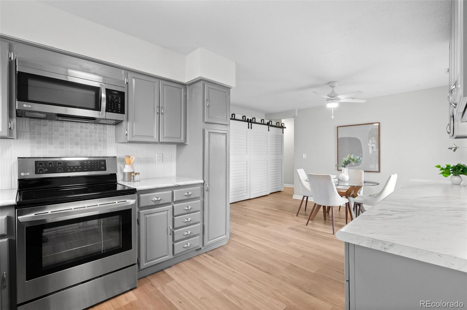 16373 East Rice Place, Unit B Aurora, CO 80015 - Photo 16 of 26 a kitchen with a stove and a microwave