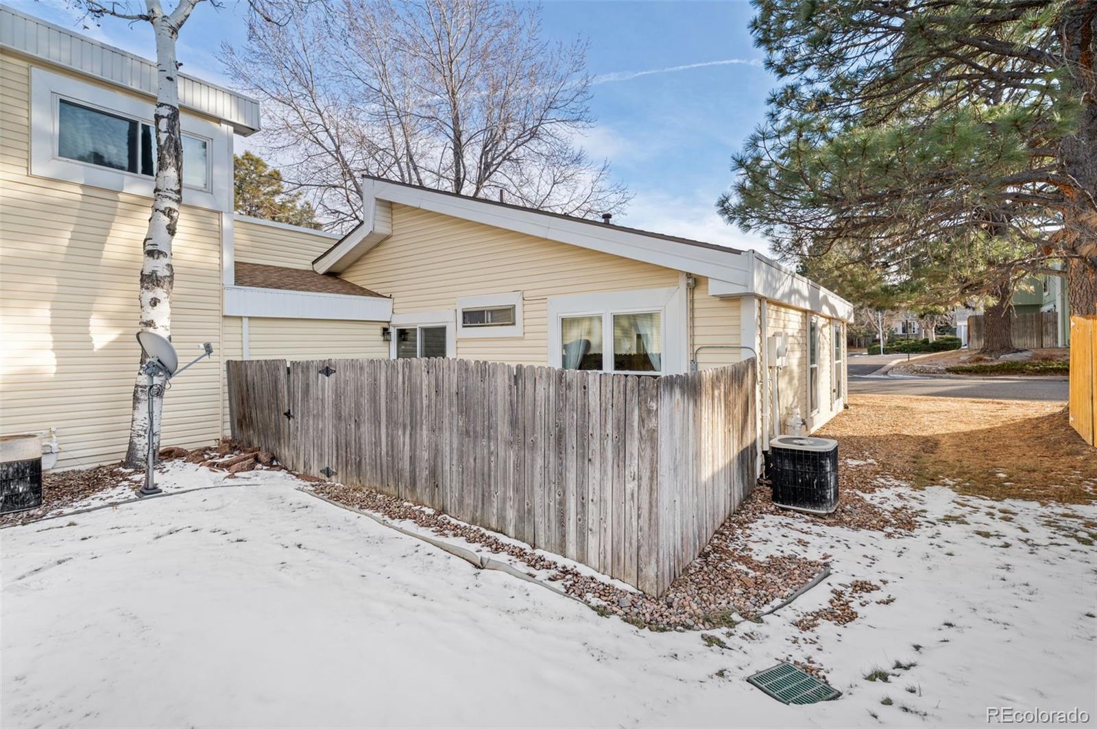 16373 East Rice Place, Unit B Aurora, CO 80015 - Photo 26 of 26 a view of a small house with wooden fence