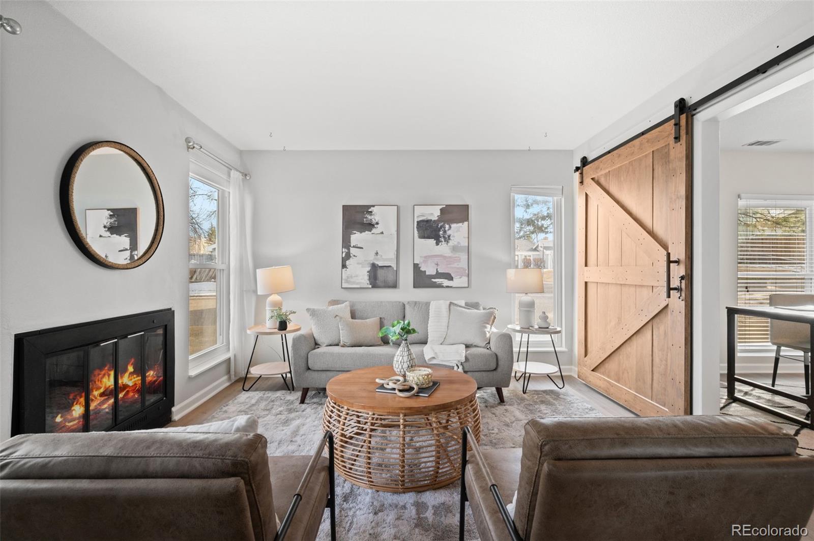 16373 East Rice Place, Unit B Aurora, CO 80015 - Photo 7 of 26 a living room with furniture a fireplace and a large window