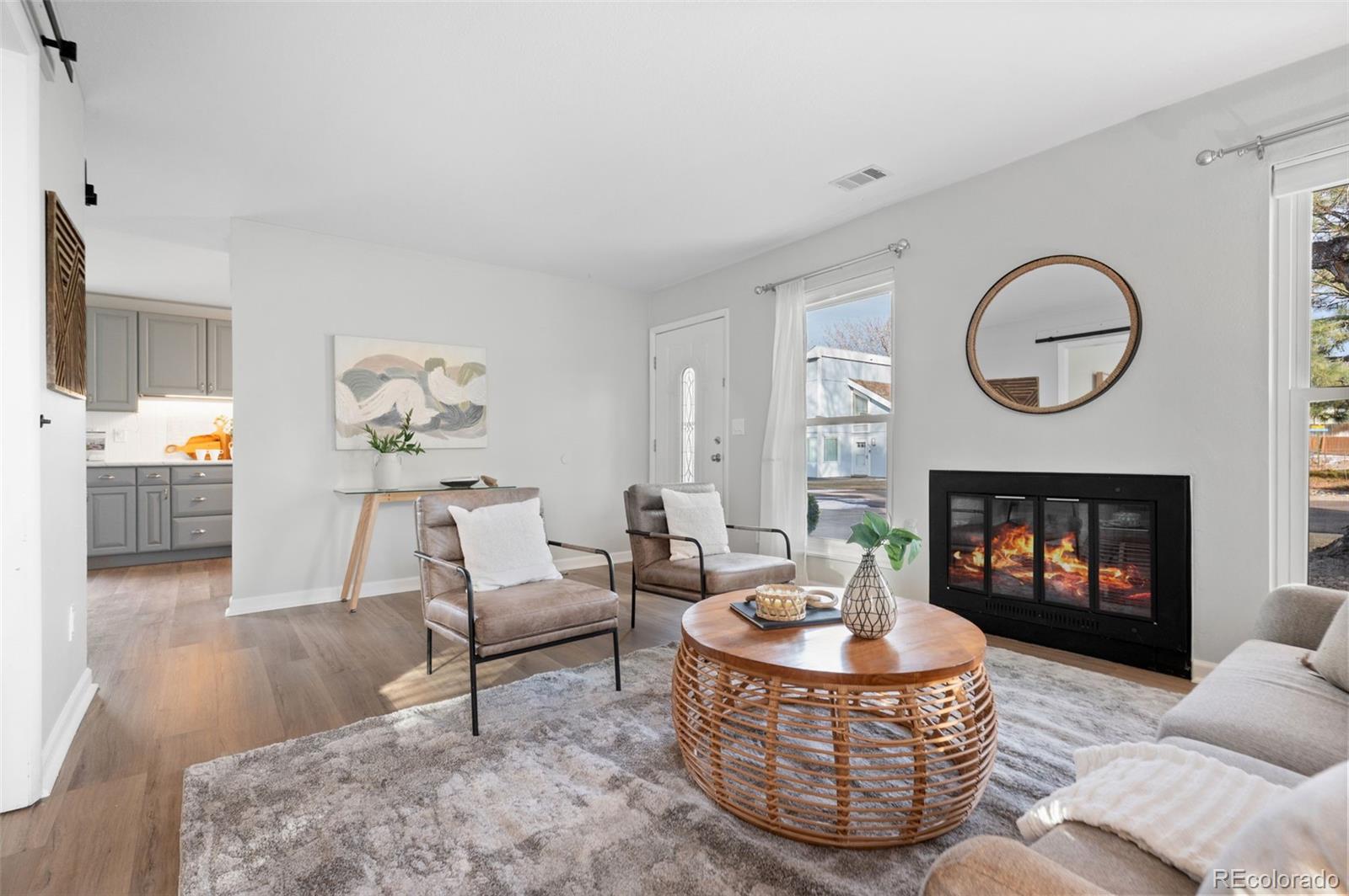 16373 East Rice Place, Unit B Aurora, CO 80015 - Photo 8 of 26 a living room with furniture a fireplace and a fireplace
