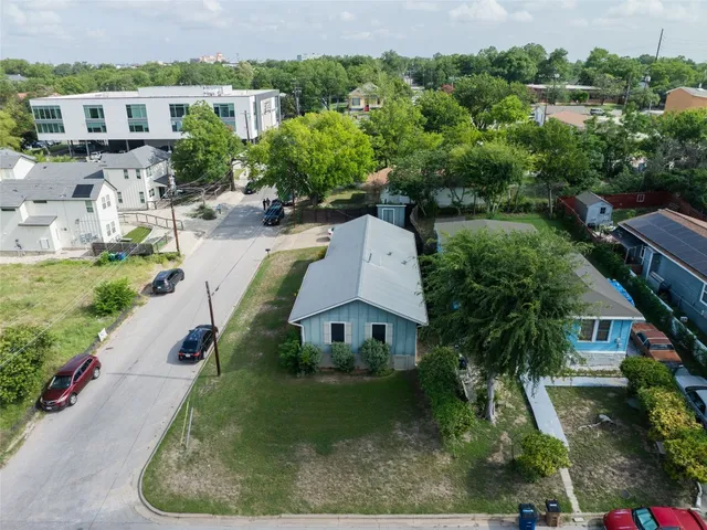 an aerial view of a house with a yard