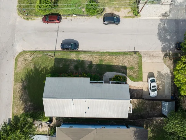 an aerial view of a house with a yard