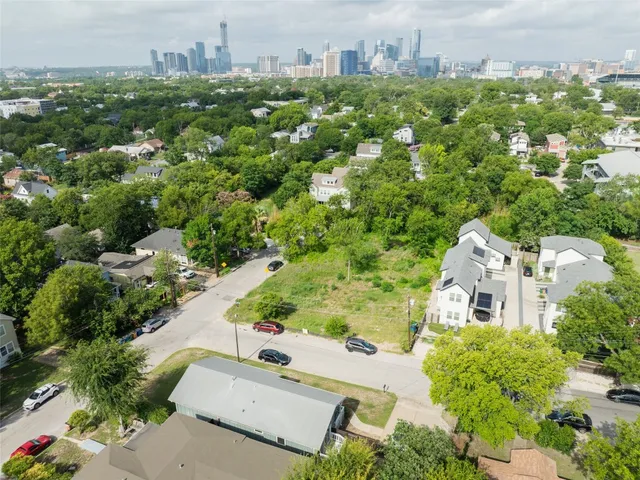 an aerial view of residential houses with city view