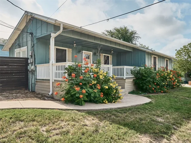 a front view of house with a garden