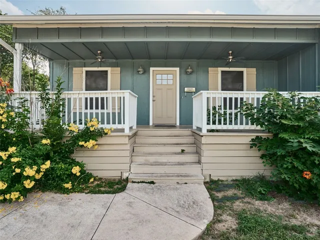 a view of a house with a small yard and plants