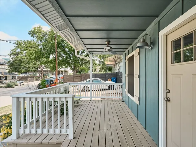 a view of deck with furniture and trees