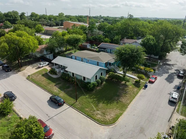 an aerial view of a house with a yard