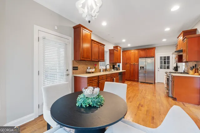 a living room with stainless steel appliances kitchen island granite countertop furniture and a kitchen view