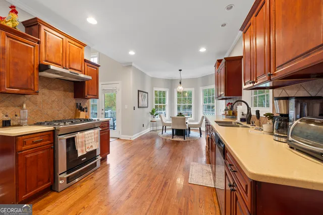 a kitchen with sink stove and cabinets