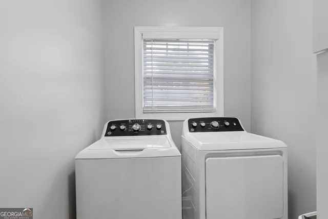 a view of storage and utility room with washer and dryer