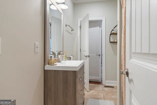 a bathroom with a sink a mirror and a shower