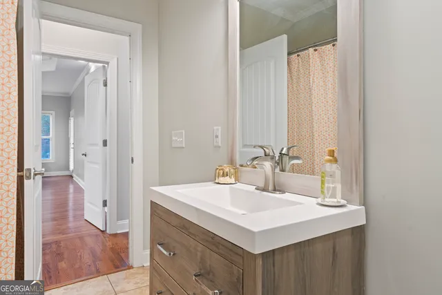 a bathroom with a sink a mirror and a vanity