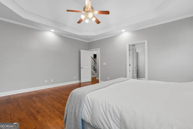 a bedroom with a large bed and a chandelier