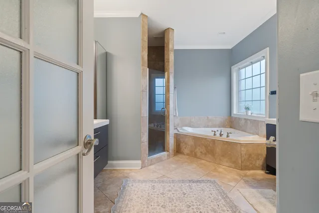 a bathroom with a tub sink and a shower