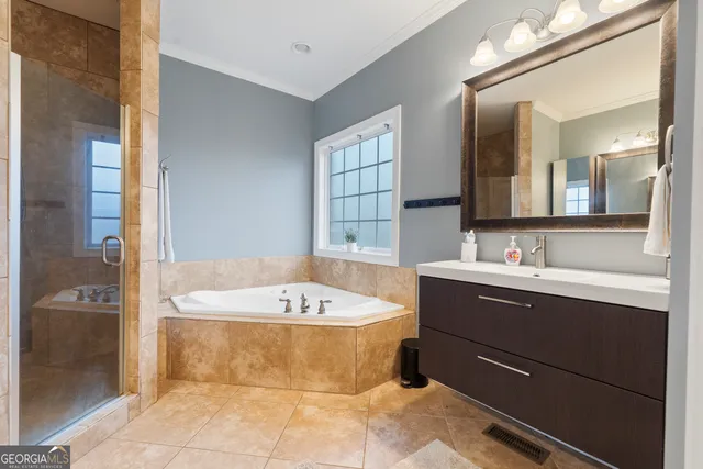 a bathroom with a bathtub sink and mirror