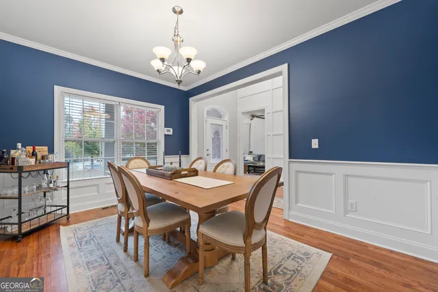 a view of a dining room with furniture window and wooden floor