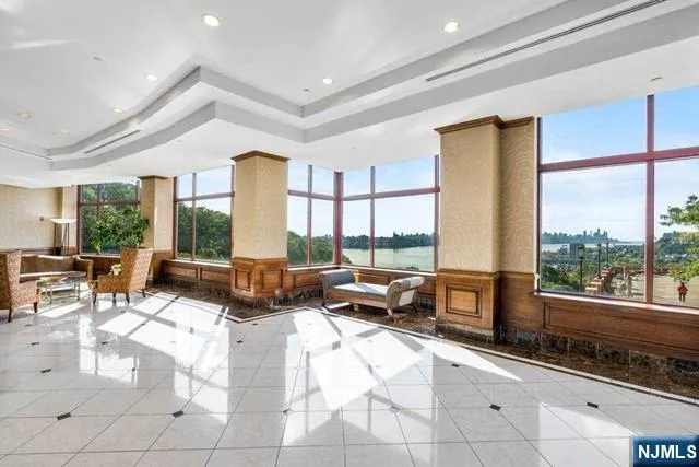 a living room with furniture and a floor to ceiling window