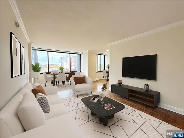 a living room with furniture a flat screen tv and a large window