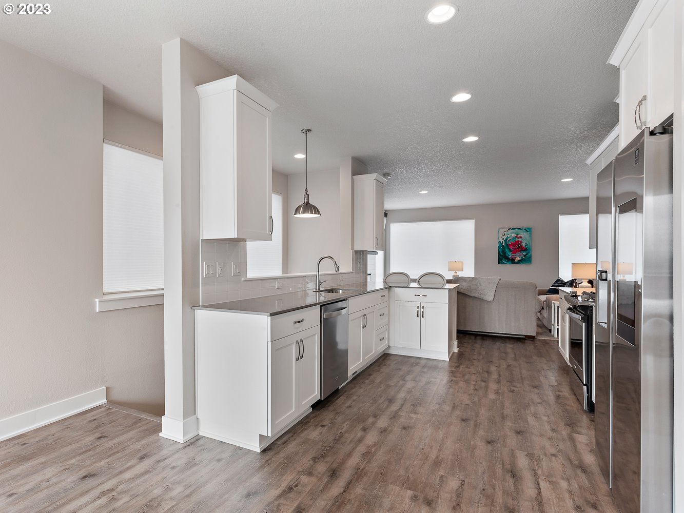 17100 Southwest Albatross Lane Beaverton, OR 97007 - Photo 14 of 48 a large white kitchen with a lot of counter space and wooden floor