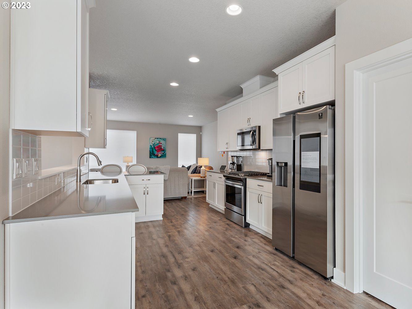 17100 Southwest Albatross Lane Beaverton, OR 97007 - Photo 15 of 48 a kitchen with white cabinets and stainless steel appliances