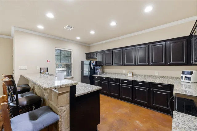 a kitchen with stainless steel appliances granite countertop a sink counter space cabinets and a counter top space
