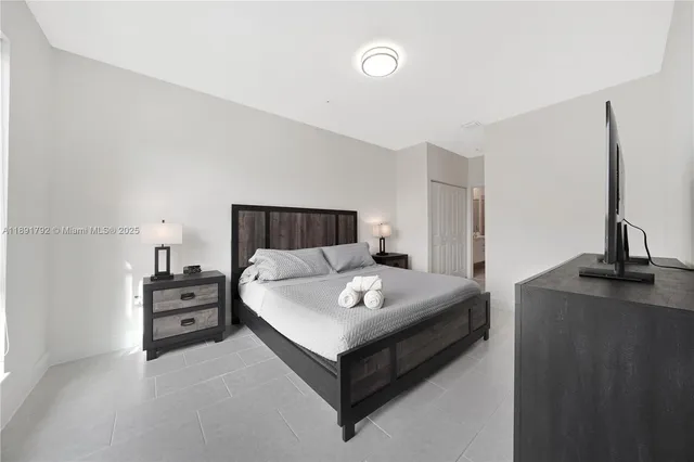 a bedroom with a bed and dresser