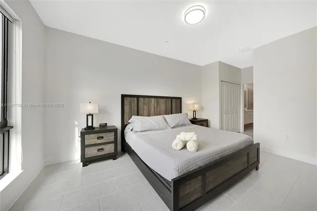 a bedroom with a bed and window