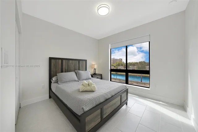 a kitchen with stainless steel appliances granite countertop white cabinets a stove top oven a sink and dishwasher