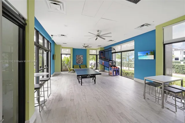 a view of a livingroom with furniture and floor to ceiling window
