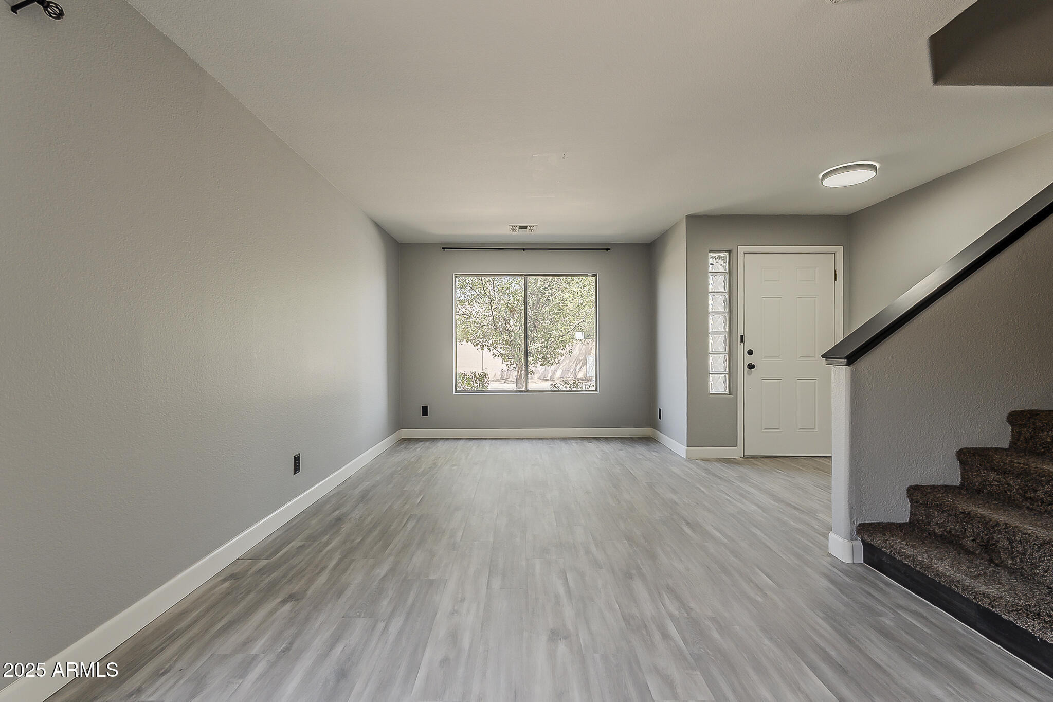 21928 North Braden Road Maricopa, AZ 85138 - Photo 11 of 58 wooden floor in an empty room with a window
