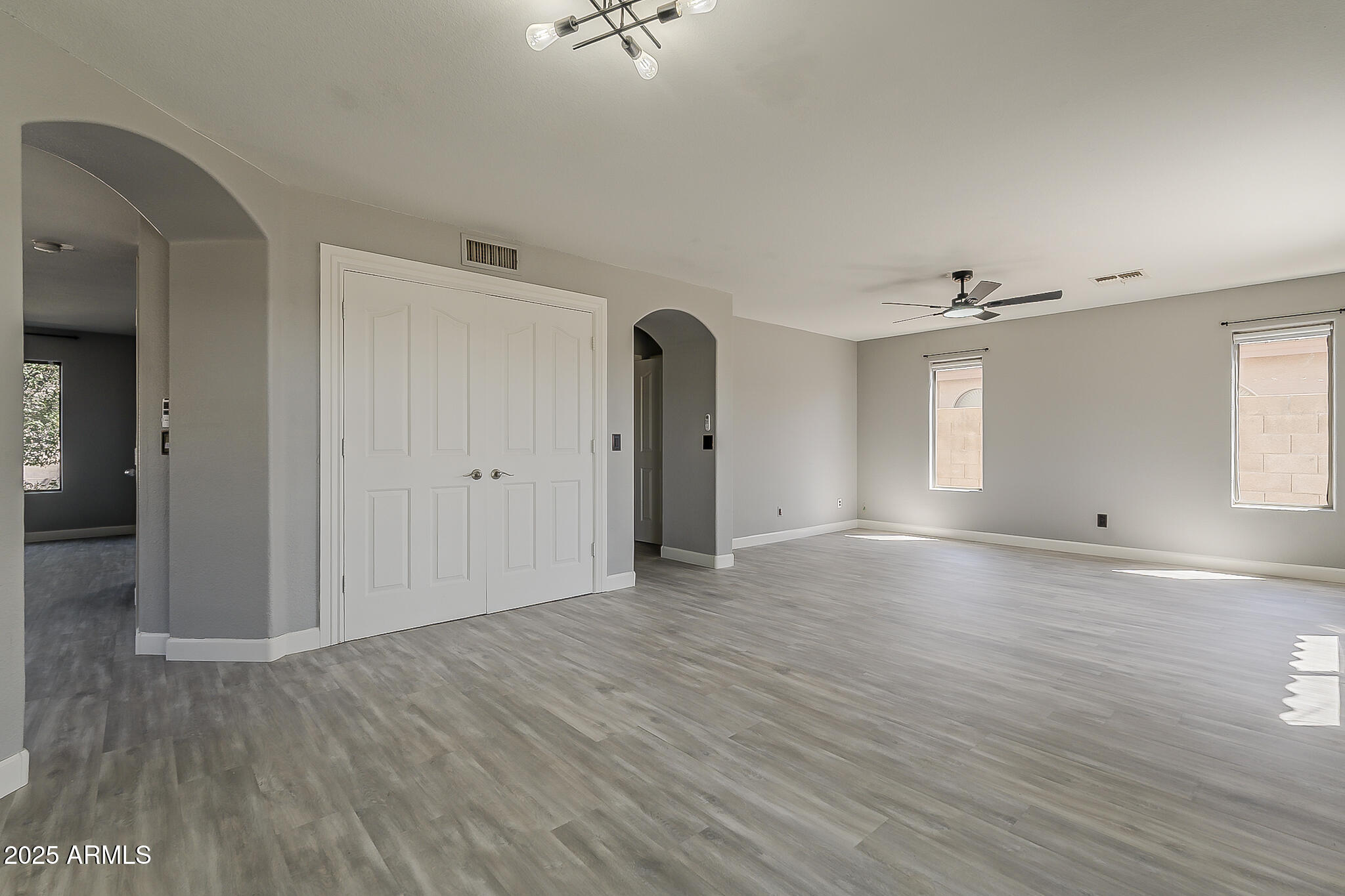 21928 North Braden Road Maricopa, AZ 85138 - Photo 13 of 58 a view of empty room with wooden floor and fan