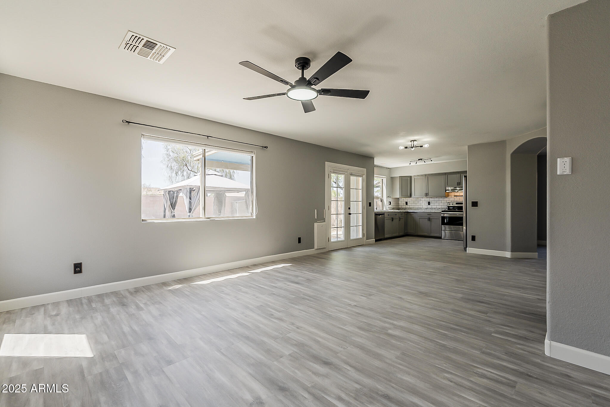 21928 North Braden Road Maricopa, AZ 85138 - Photo 15 of 58 a view of empty room with wooden floor and window