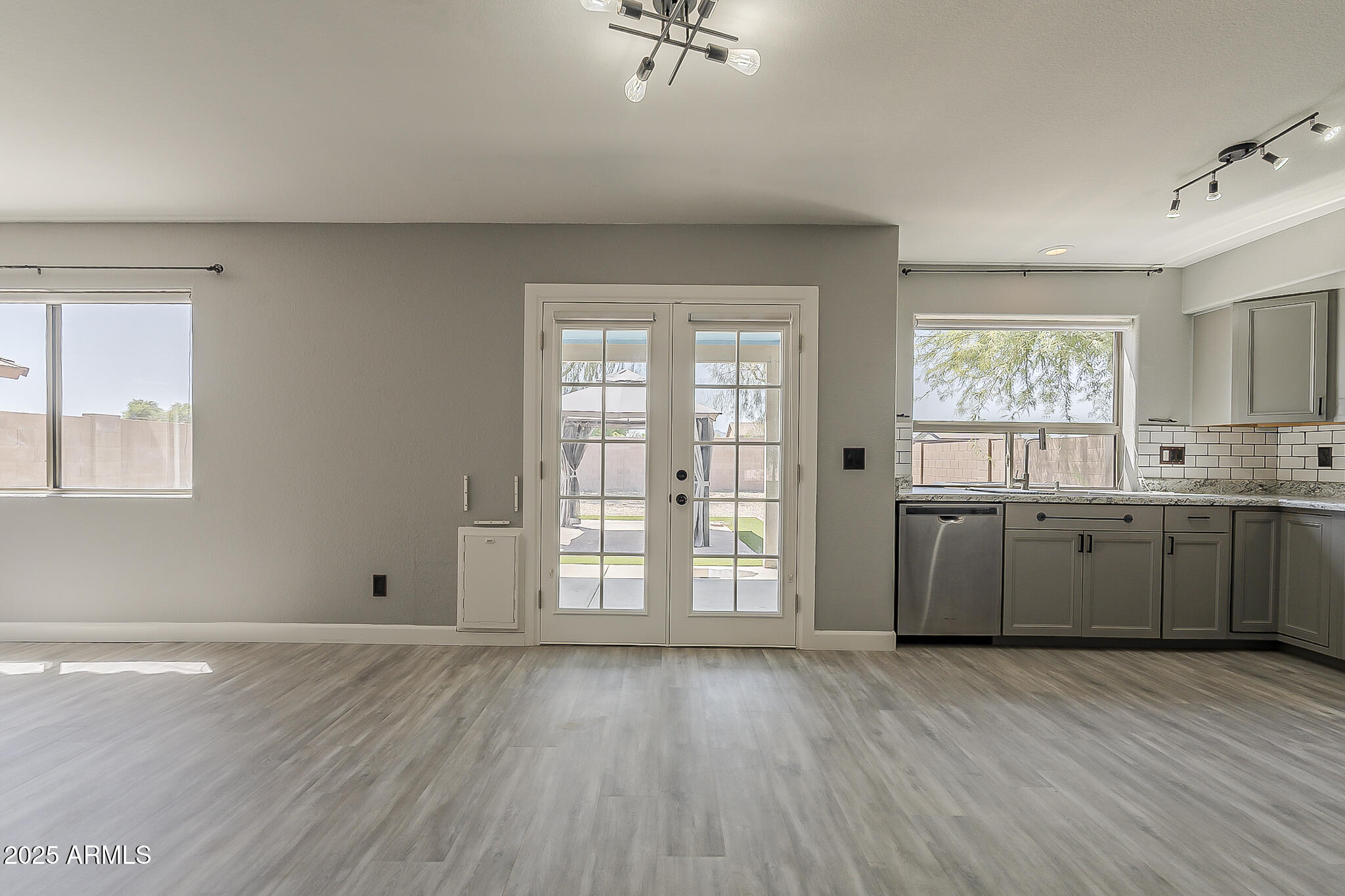 21928 North Braden Road Maricopa, AZ 85138 - Photo 16 of 58 a view of a kitchen with wooden floor and a window