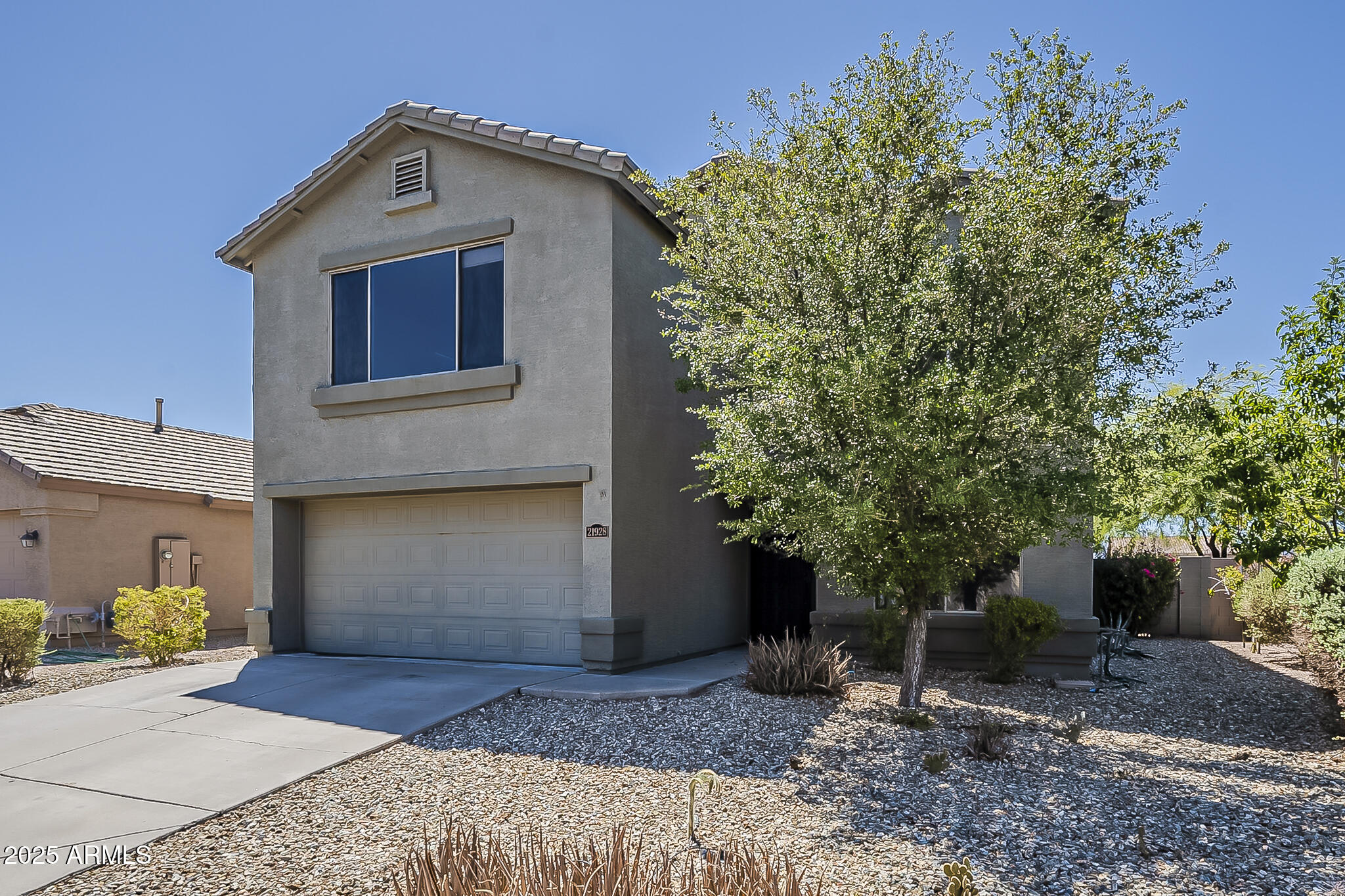 21928 North Braden Road Maricopa, AZ 85138 - Photo 2 of 58 a front view of a house with garden