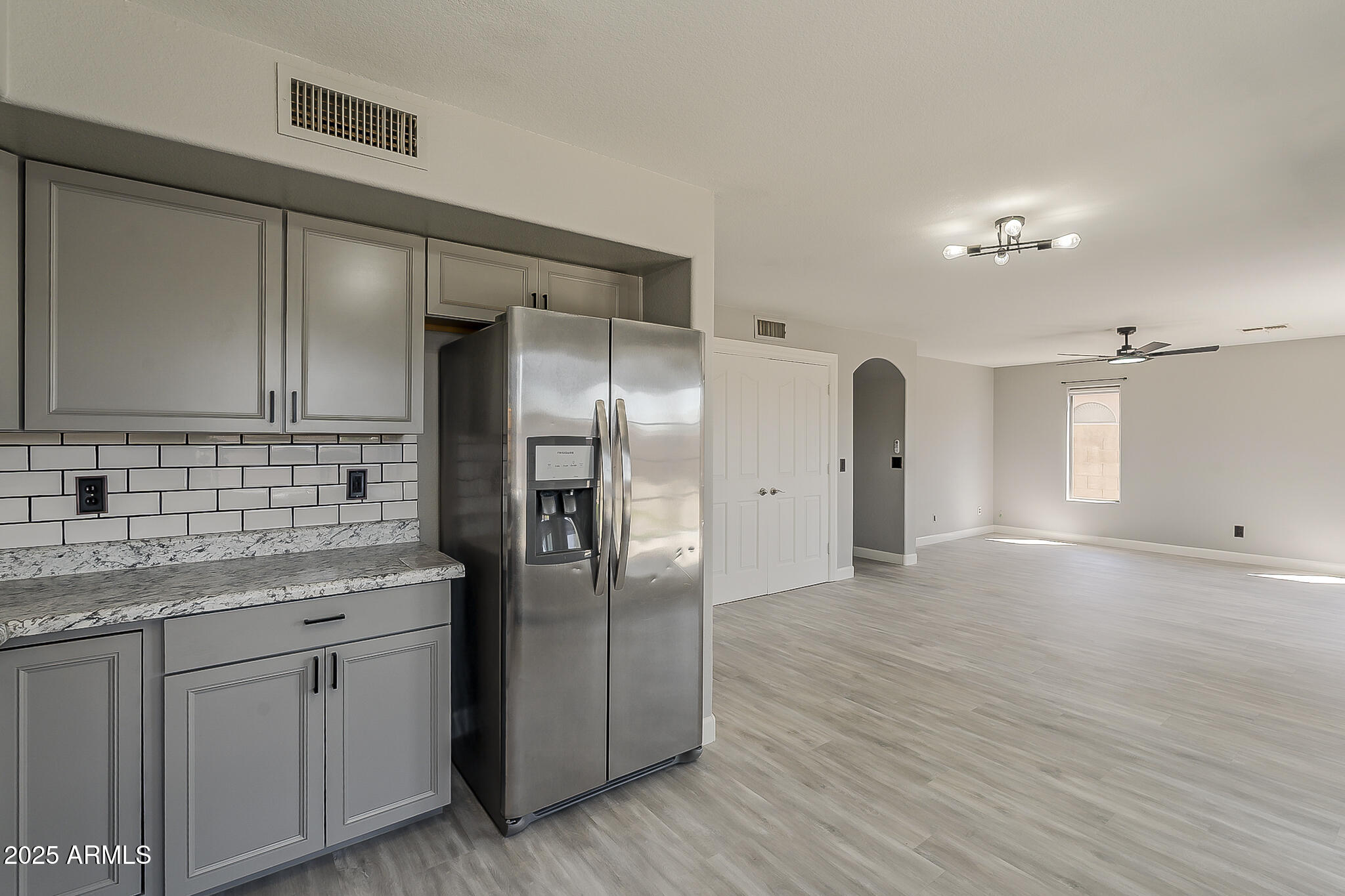 21928 North Braden Road Maricopa, AZ 85138 - Photo 21 of 58 a kitchen with stainless steel appliances granite countertop a refrigerator and a sink