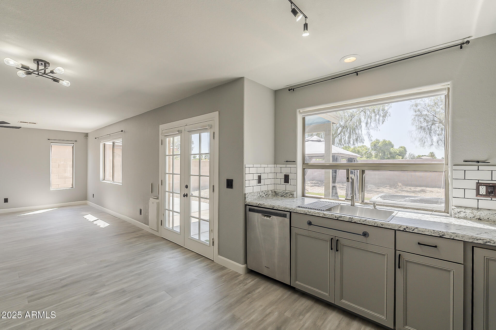 21928 North Braden Road Maricopa, AZ 85138 - Photo 22 of 58 a kitchen with a sink windows and a view of living room