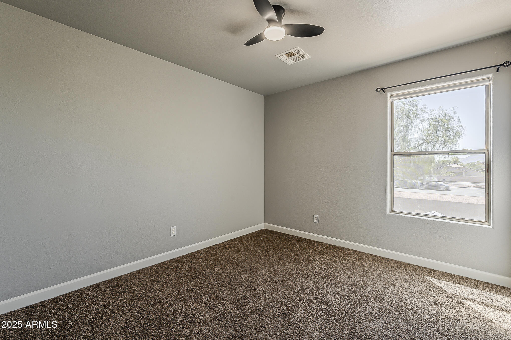 21928 North Braden Road Maricopa, AZ 85138 - Photo 33 of 58 an empty room with a window