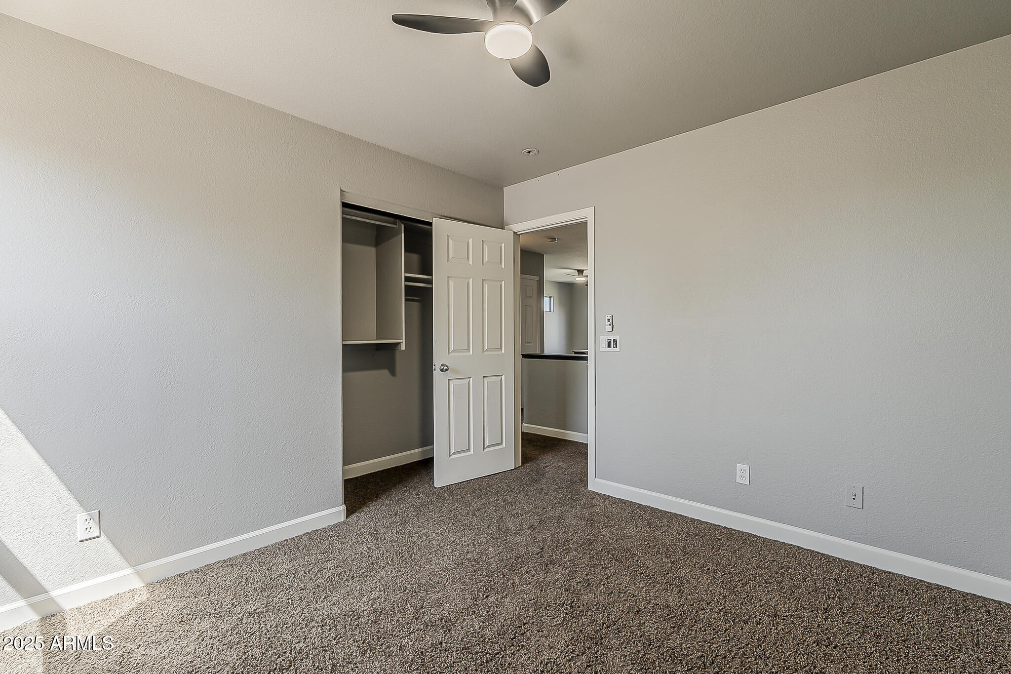 21928 North Braden Road Maricopa, AZ 85138 - Photo 34 of 58 an empty room with chandelier fan and kitchen view