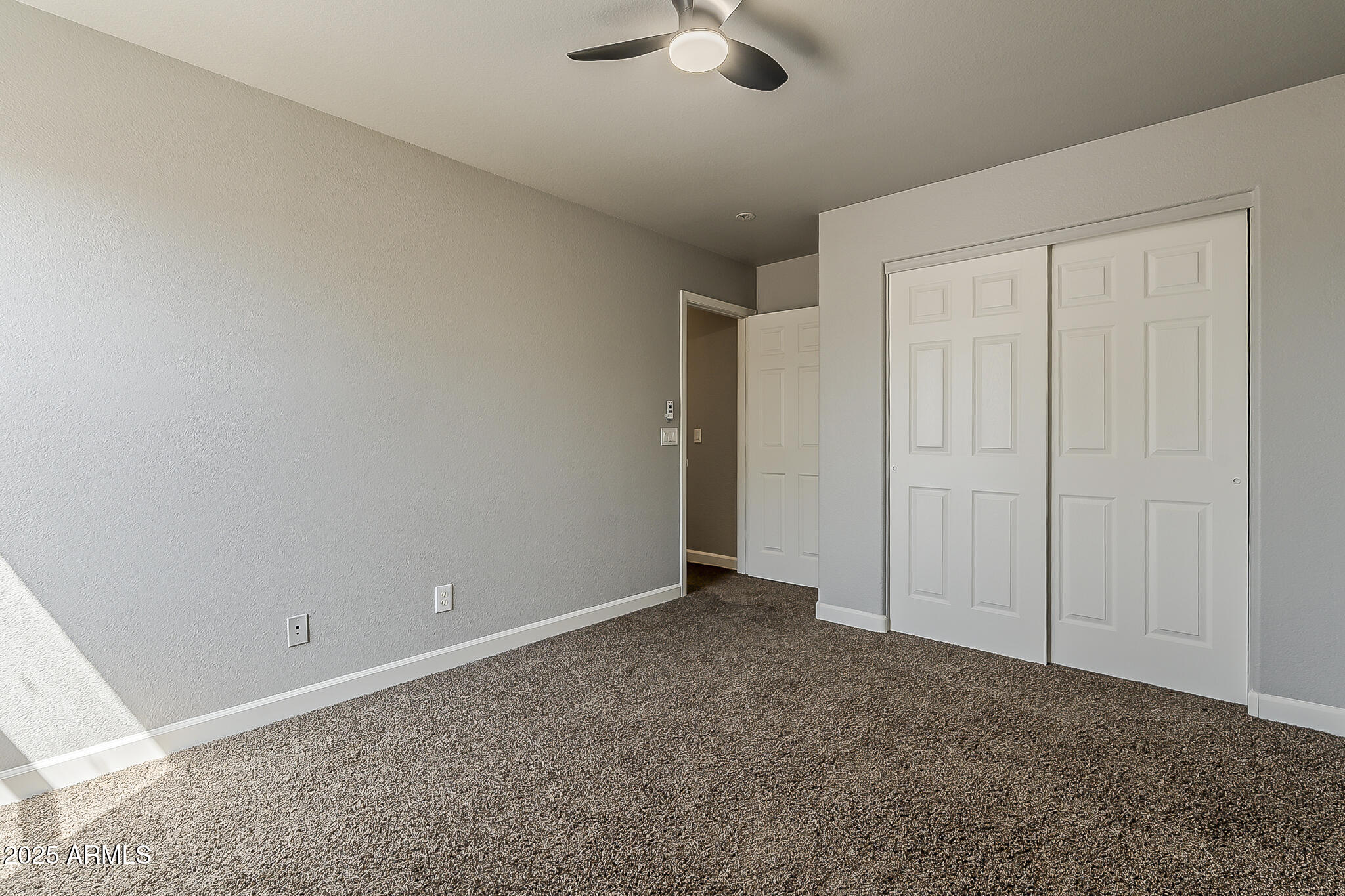 21928 North Braden Road Maricopa, AZ 85138 - Photo 36 of 58 a view of an empty room and chandelier fan