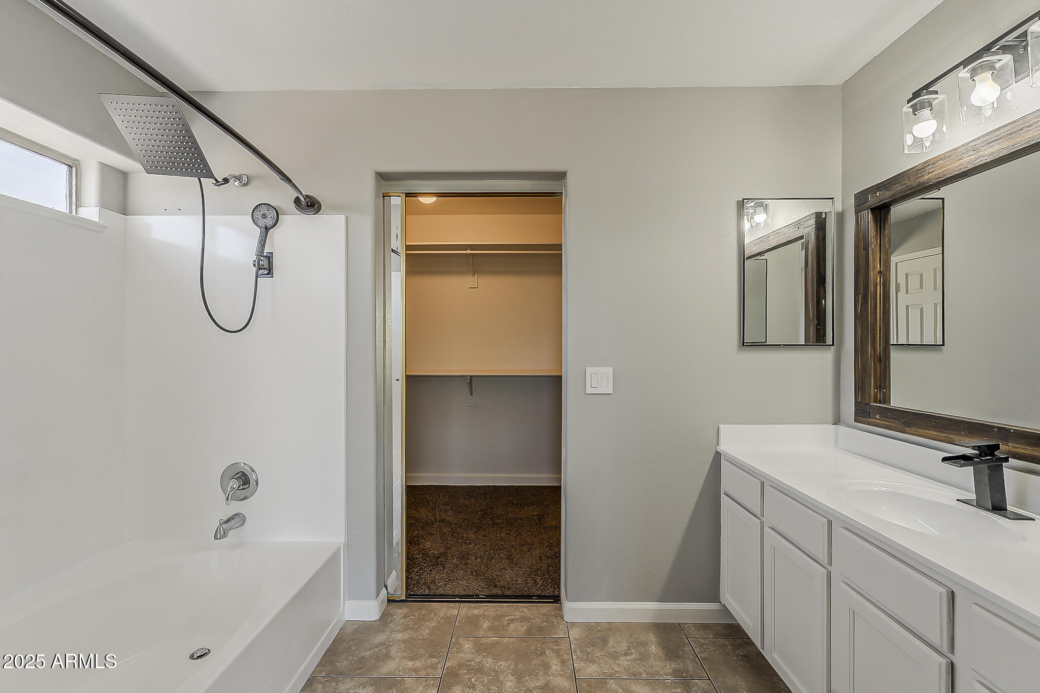 21928 North Braden Road Maricopa, AZ 85138 - Photo 43 of 58 a bathroom with a tub sink and mirror