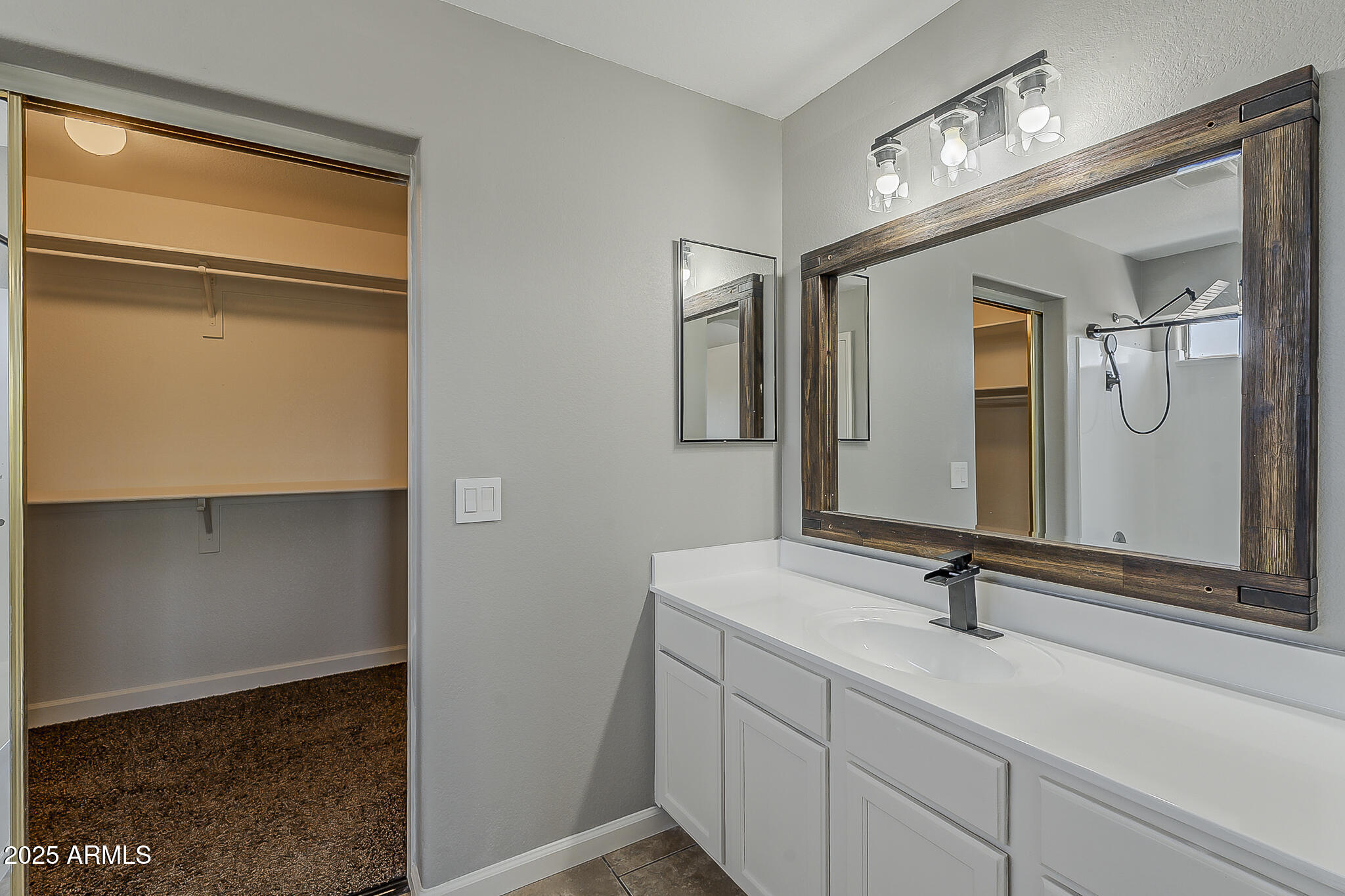 21928 North Braden Road Maricopa, AZ 85138 - Photo 44 of 58 a bathroom with a sink and a mirror