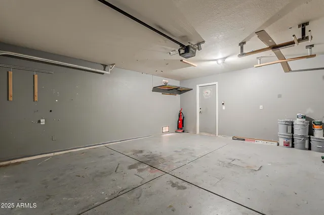 a view of a patio with a table and chairs under an umbrella