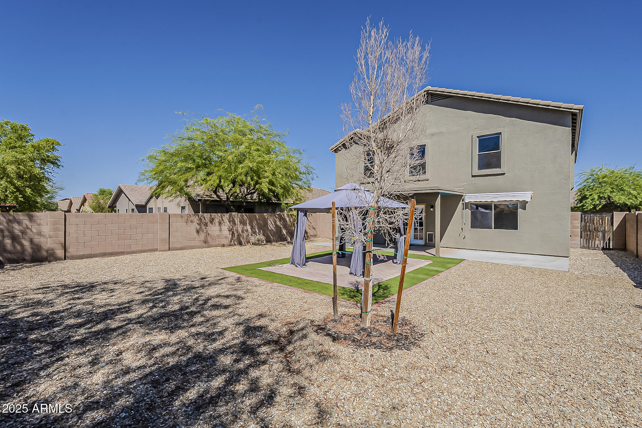 21928 North Braden Road Maricopa, AZ 85138 - Photo 54 of 58 a view of a house with backyard and a patio