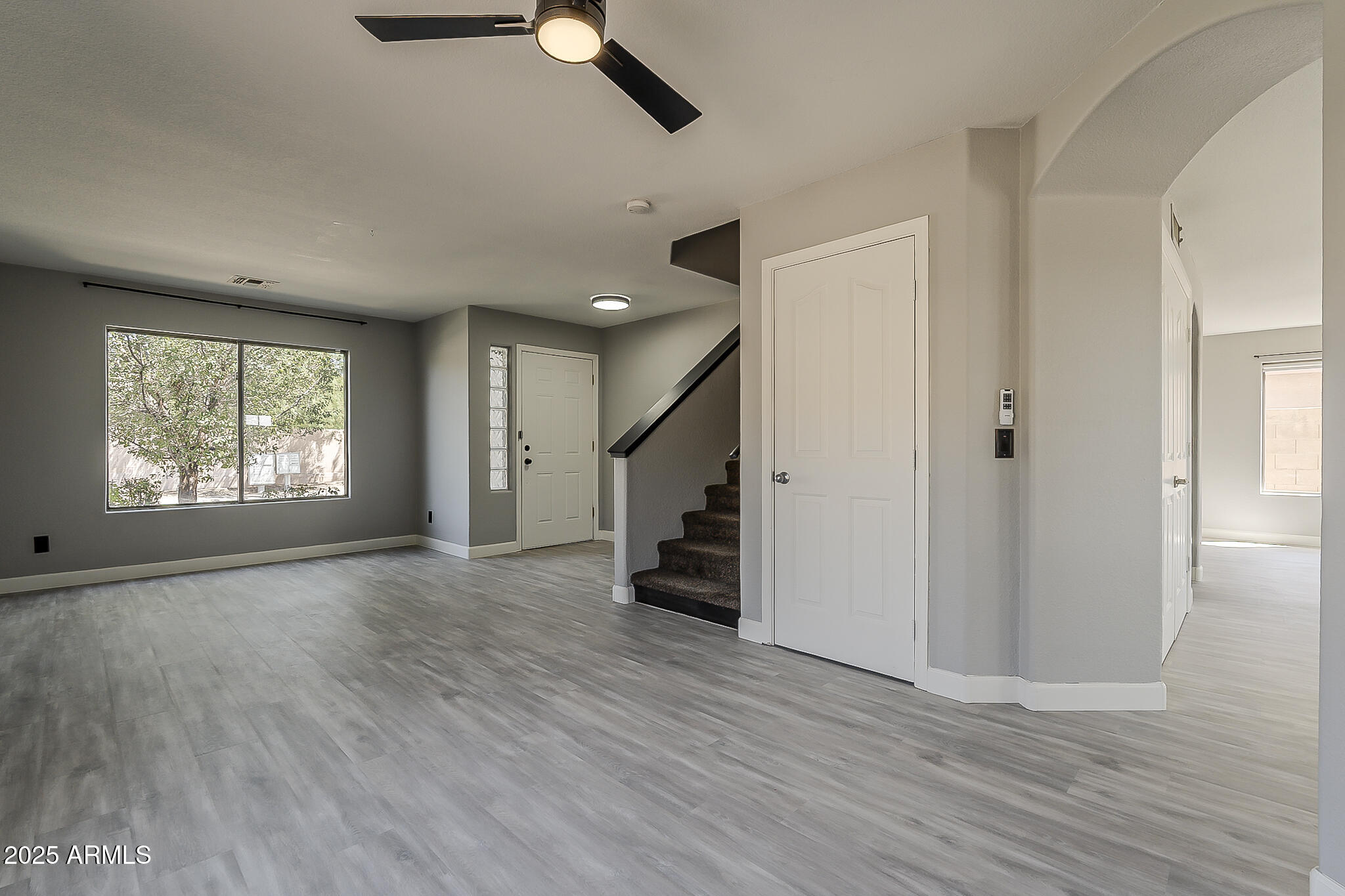 21928 North Braden Road Maricopa, AZ 85138 - Photo 9 of 58 an empty room with wooden floor cabinet and windows